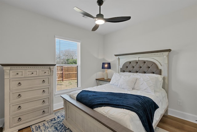 bedroom featuring ceiling fan and dark hardwood / wood-style flooring