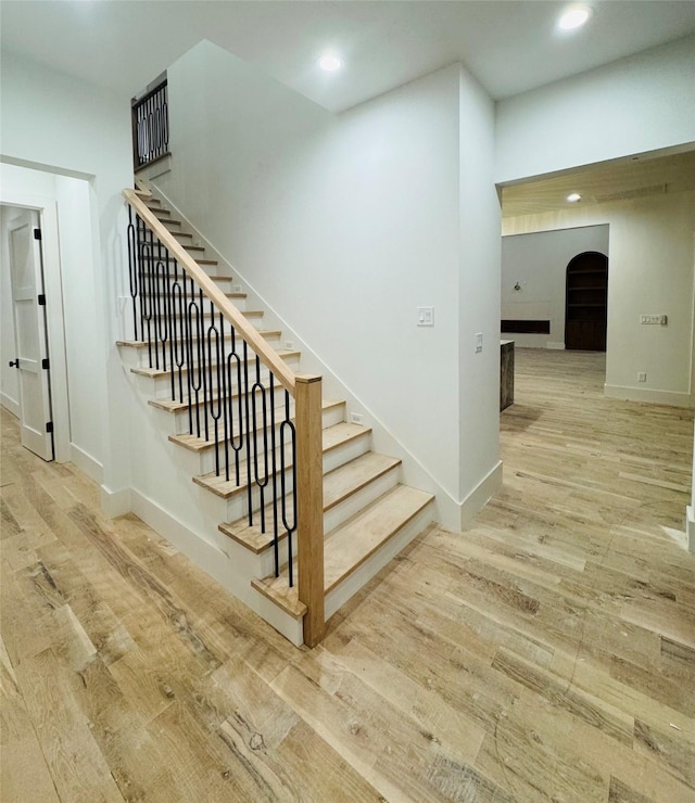 staircase with hardwood / wood-style floors