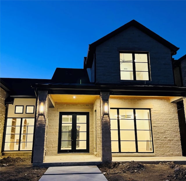 view of front of property featuring a garage and french doors