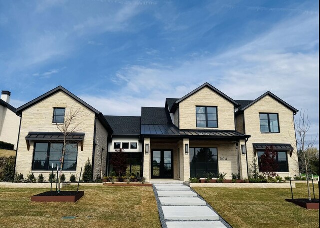 view of front of house with a front yard and french doors