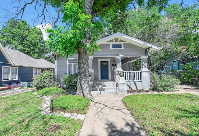 view of front of house with a porch and a front lawn