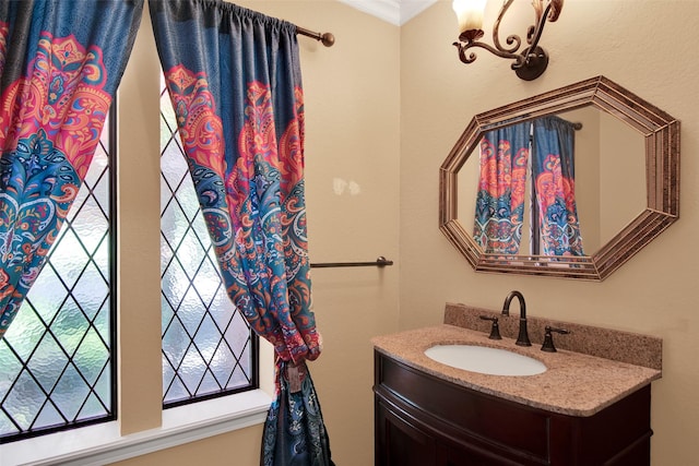 bathroom with vanity and ornamental molding