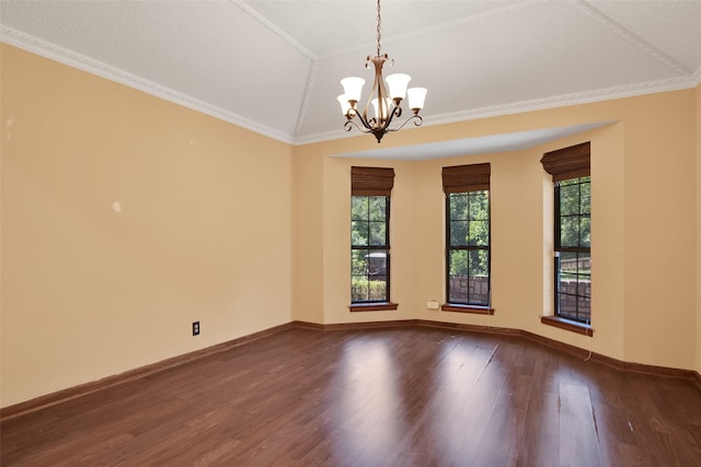 empty room with dark hardwood / wood-style flooring, lofted ceiling, an inviting chandelier, and ornamental molding