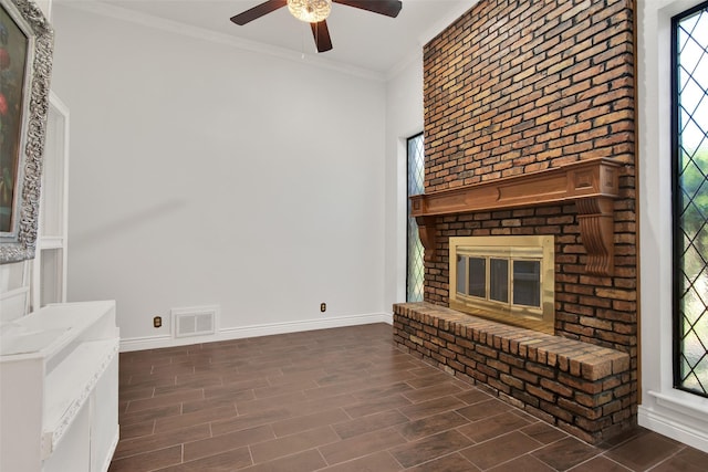 unfurnished living room featuring ceiling fan, a fireplace, and ornamental molding