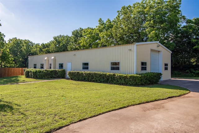 exterior space featuring an outbuilding, a garage, and a front lawn