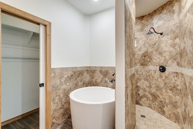 bathroom featuring independent shower and bath and wood-type flooring