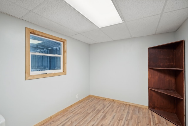 interior space with a paneled ceiling and wood-type flooring