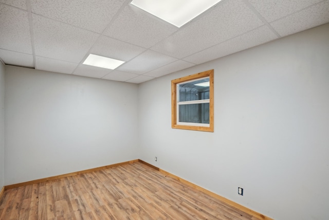 unfurnished room featuring a drop ceiling and wood-type flooring