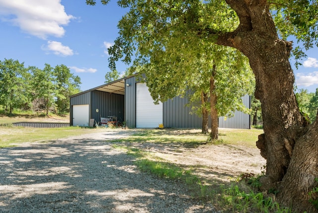 view of side of property featuring an outdoor structure and a garage