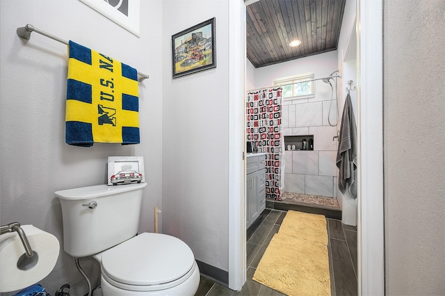 bathroom with ornamental molding, wooden ceiling, toilet, and walk in shower