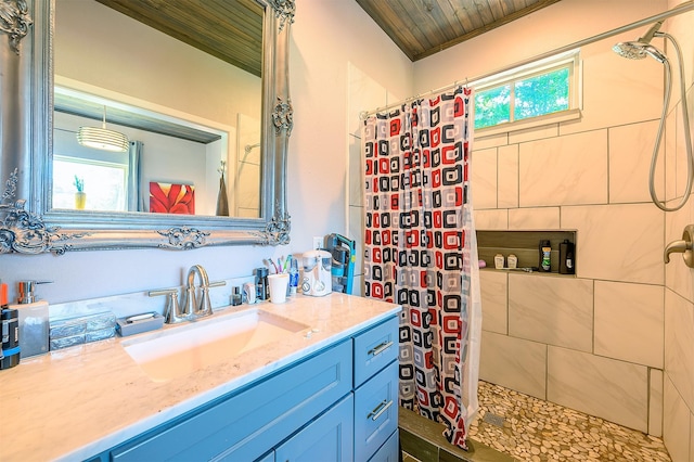 bathroom with vanity, wood ceiling, a healthy amount of sunlight, and walk in shower