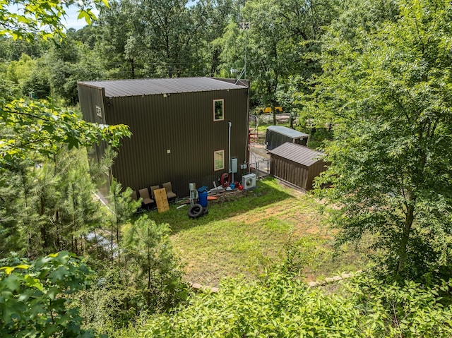 view of home's exterior featuring an outdoor structure and a lawn