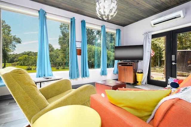 interior space featuring wood ceiling, french doors, and an AC wall unit