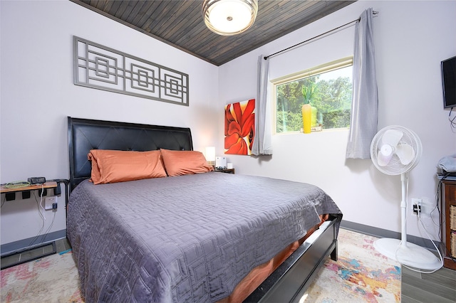 bedroom featuring hardwood / wood-style floors and wooden ceiling