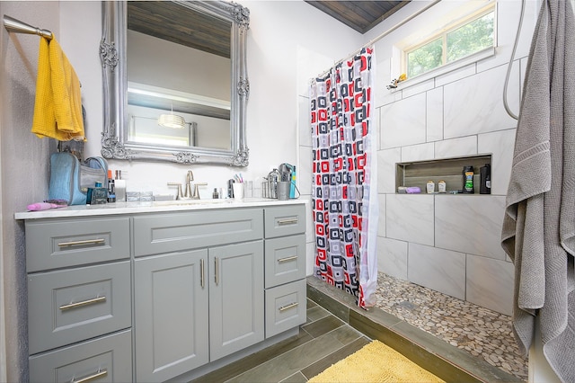 bathroom featuring vanity and a shower with shower curtain