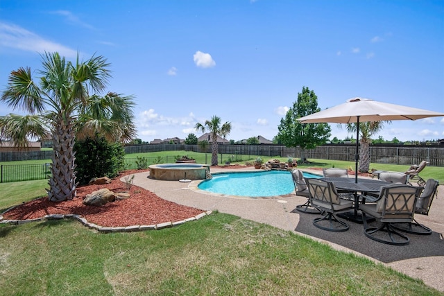 view of pool with a patio, a yard, a fenced backyard, and a pool with connected hot tub