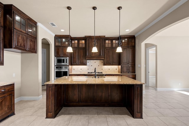 kitchen with arched walkways, visible vents, backsplash, and appliances with stainless steel finishes