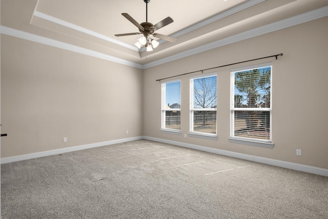 unfurnished room featuring light carpet, baseboards, and a tray ceiling