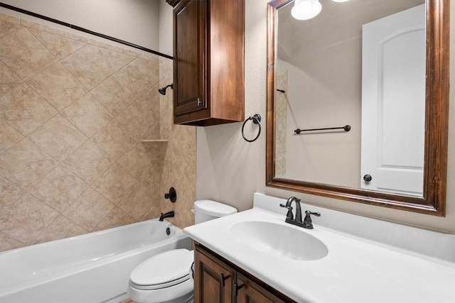 bathroom with toilet,  shower combination, vanity, and a textured wall