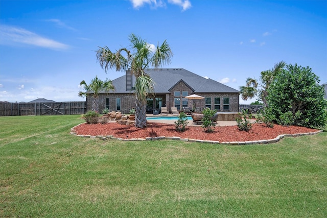 back of property featuring brick siding, a yard, fence, and a fenced in pool