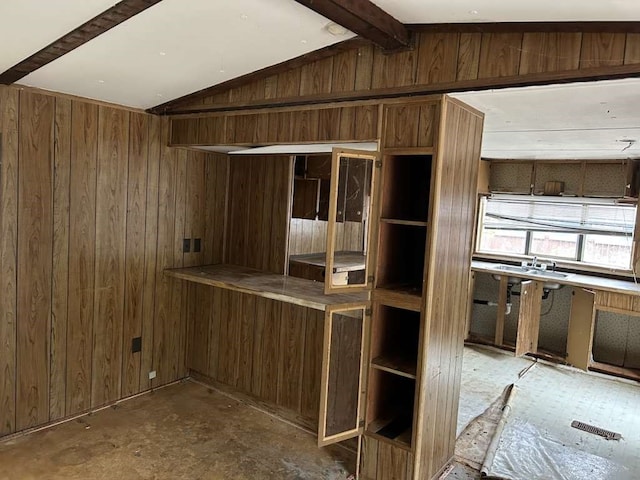 kitchen featuring wooden walls and vaulted ceiling