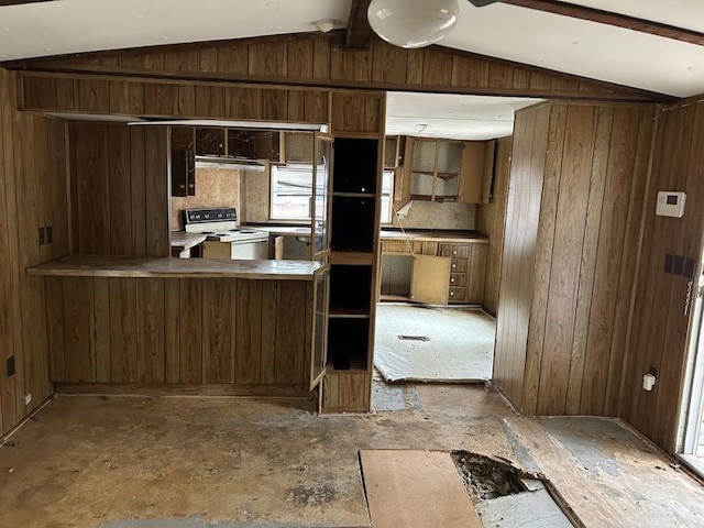 kitchen featuring electric range, wooden walls, kitchen peninsula, and lofted ceiling