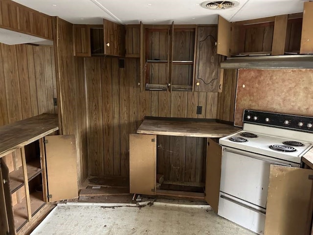 kitchen featuring range hood, white electric stove, and wooden walls