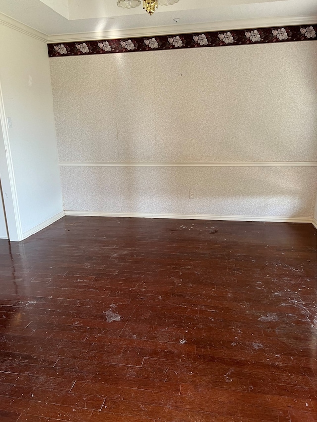 unfurnished room featuring dark hardwood / wood-style flooring and crown molding