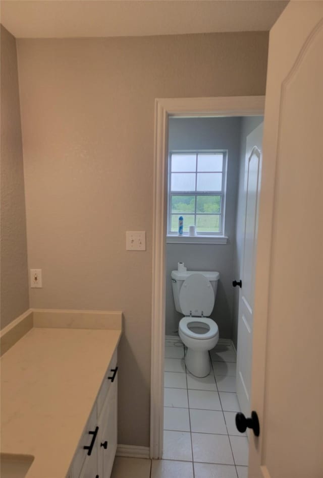 bathroom featuring vanity, tile patterned flooring, and toilet