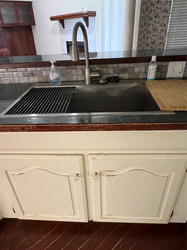 kitchen with sink, tasteful backsplash, and dark hardwood / wood-style floors