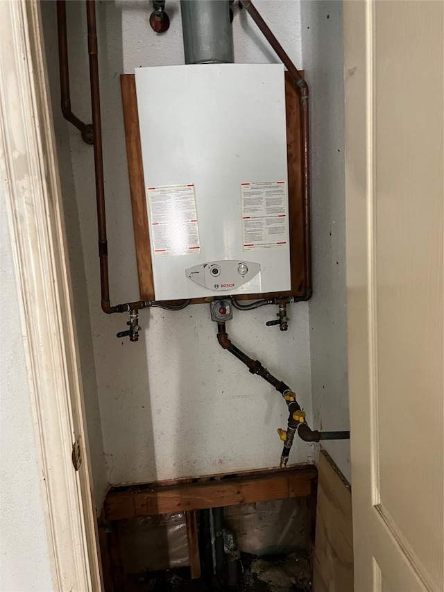 utility room featuring water heater