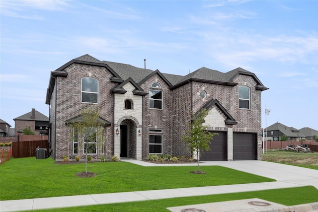 french country style house featuring a garage, a front lawn, and central AC