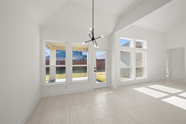 interior space with a chandelier, high vaulted ceiling, and light tile patterned flooring