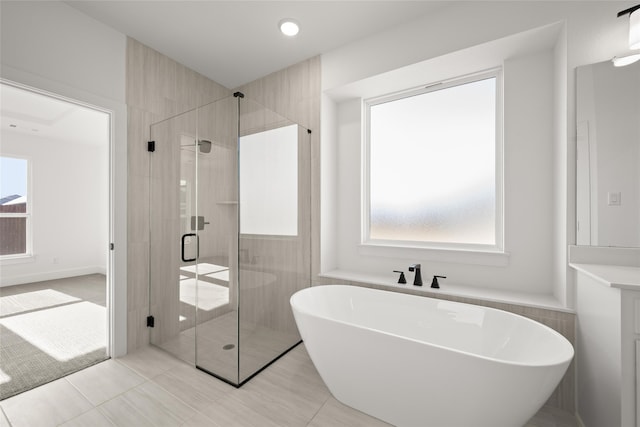 bathroom with tile patterned flooring and plus walk in shower