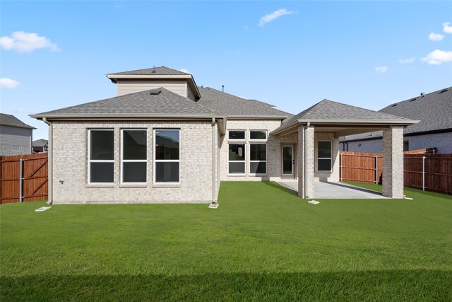 back of property featuring a lawn and a patio area