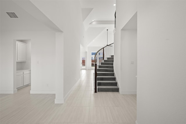 hall with light tile patterned floors