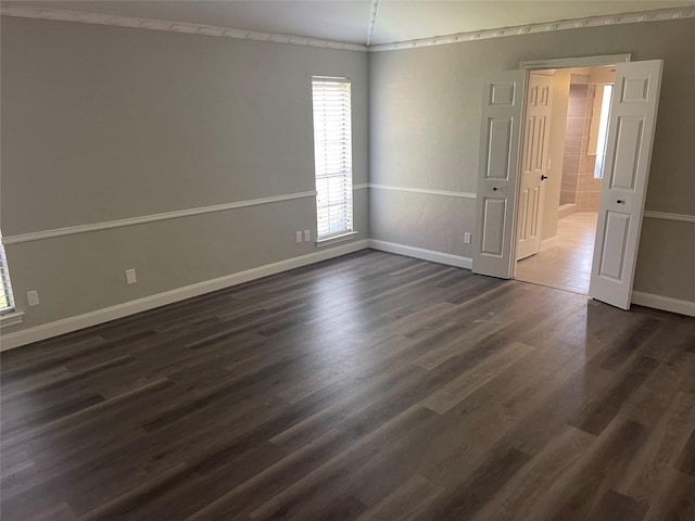 spare room with crown molding, dark hardwood / wood-style flooring, and lofted ceiling