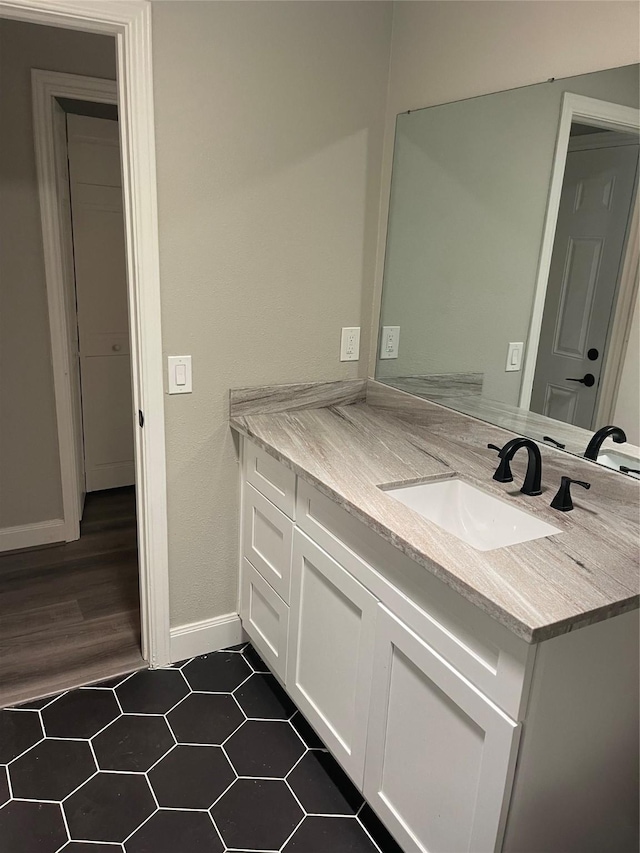 bathroom with tile patterned flooring and vanity