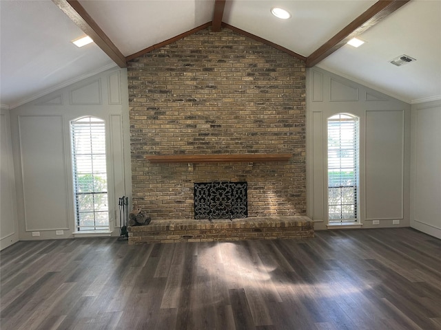 unfurnished living room with lofted ceiling with beams, dark hardwood / wood-style floors, and a brick fireplace