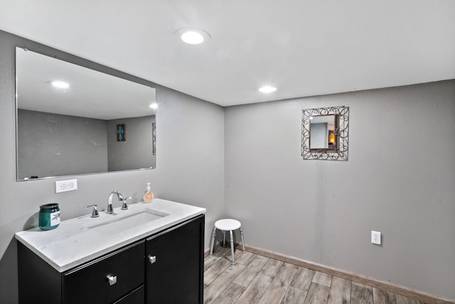 bathroom with vanity and hardwood / wood-style flooring