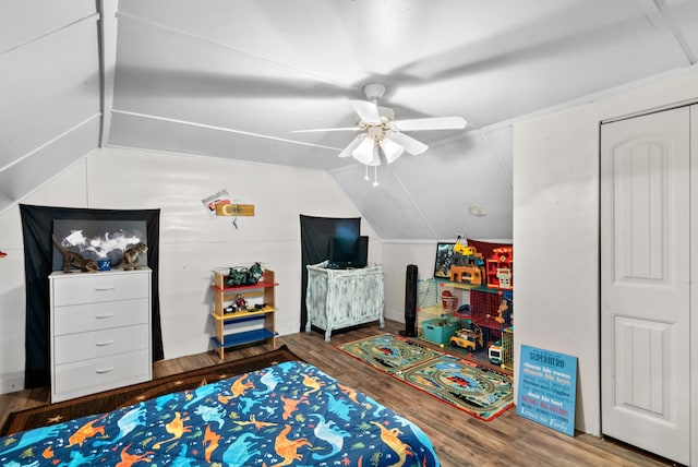 bedroom with ceiling fan, wood-type flooring, and lofted ceiling