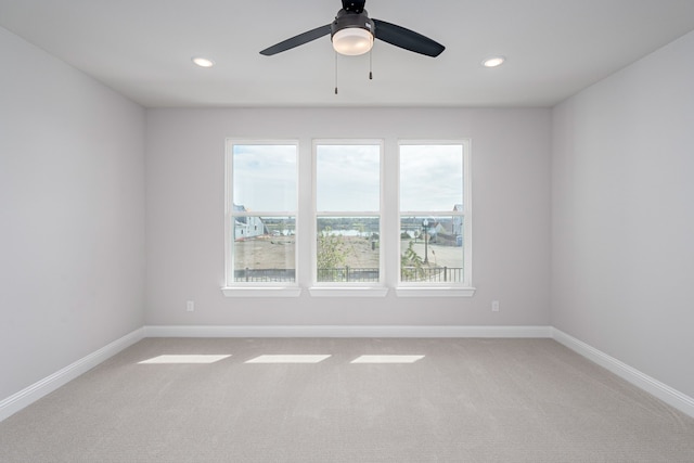 empty room with ceiling fan and carpet floors