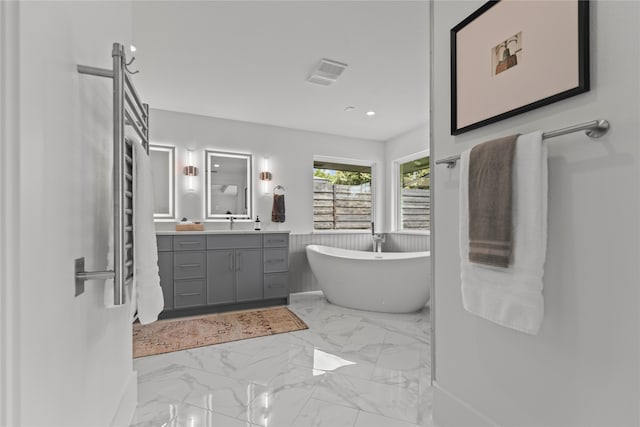 bathroom featuring vanity and a bath