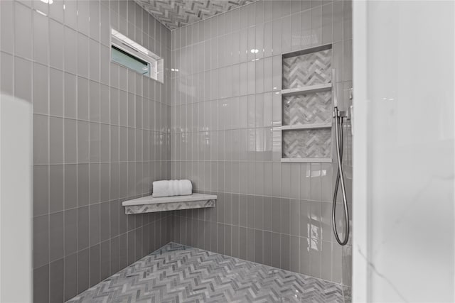 bathroom with a tile shower