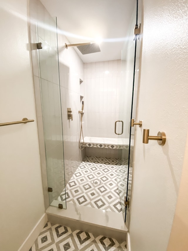 bathroom with a shower with door