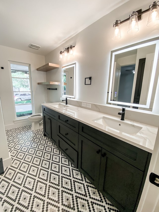 bathroom featuring vanity, tile patterned floors, and toilet