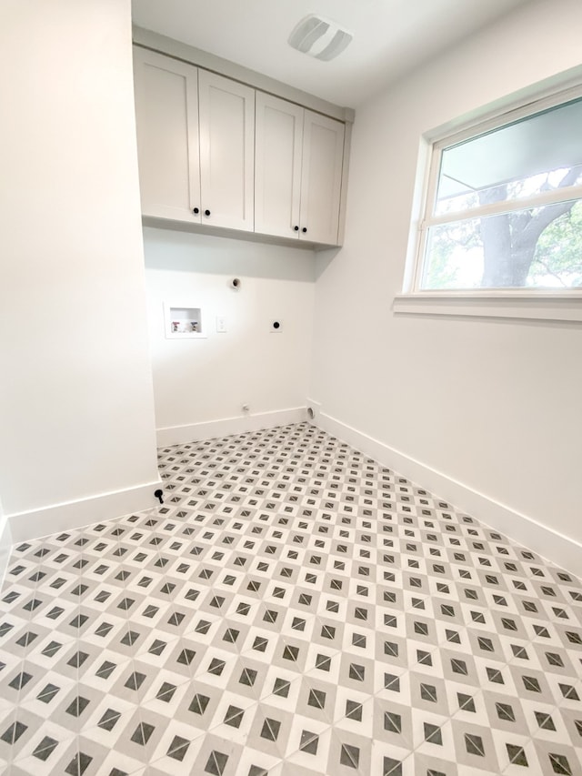 washroom with cabinets, gas dryer hookup, and hookup for an electric dryer