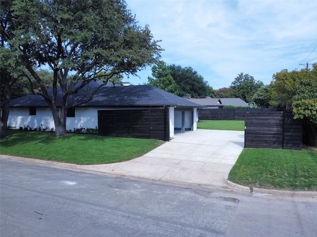 ranch-style house featuring a garage and a front yard