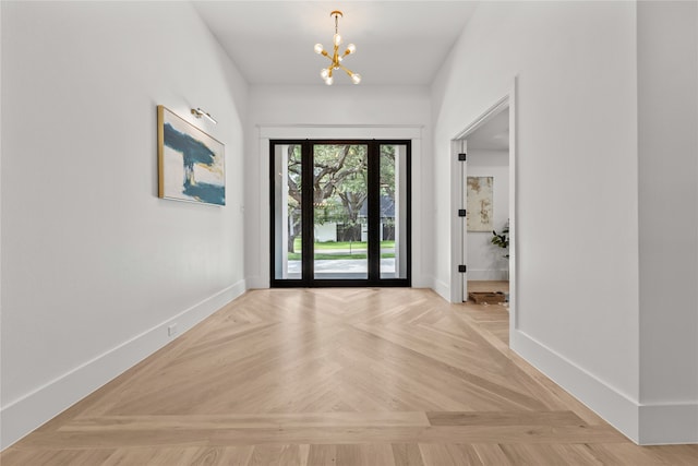 entrance foyer featuring a notable chandelier and light parquet floors