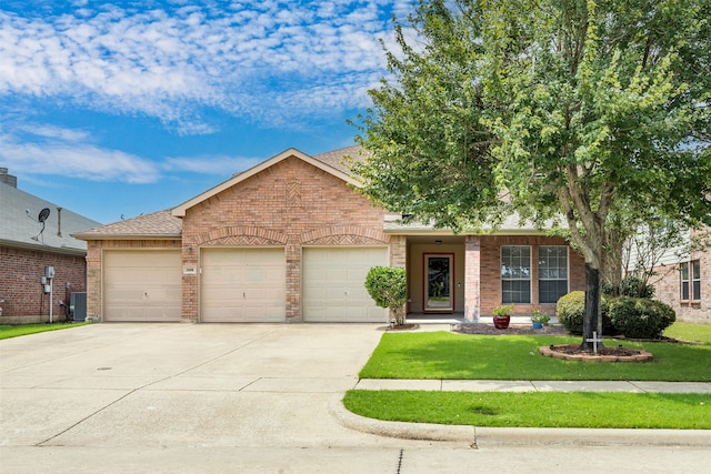 view of front of property featuring a garage, central AC unit, and a front lawn